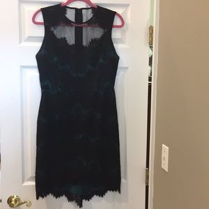 Black lace dress with green under layer